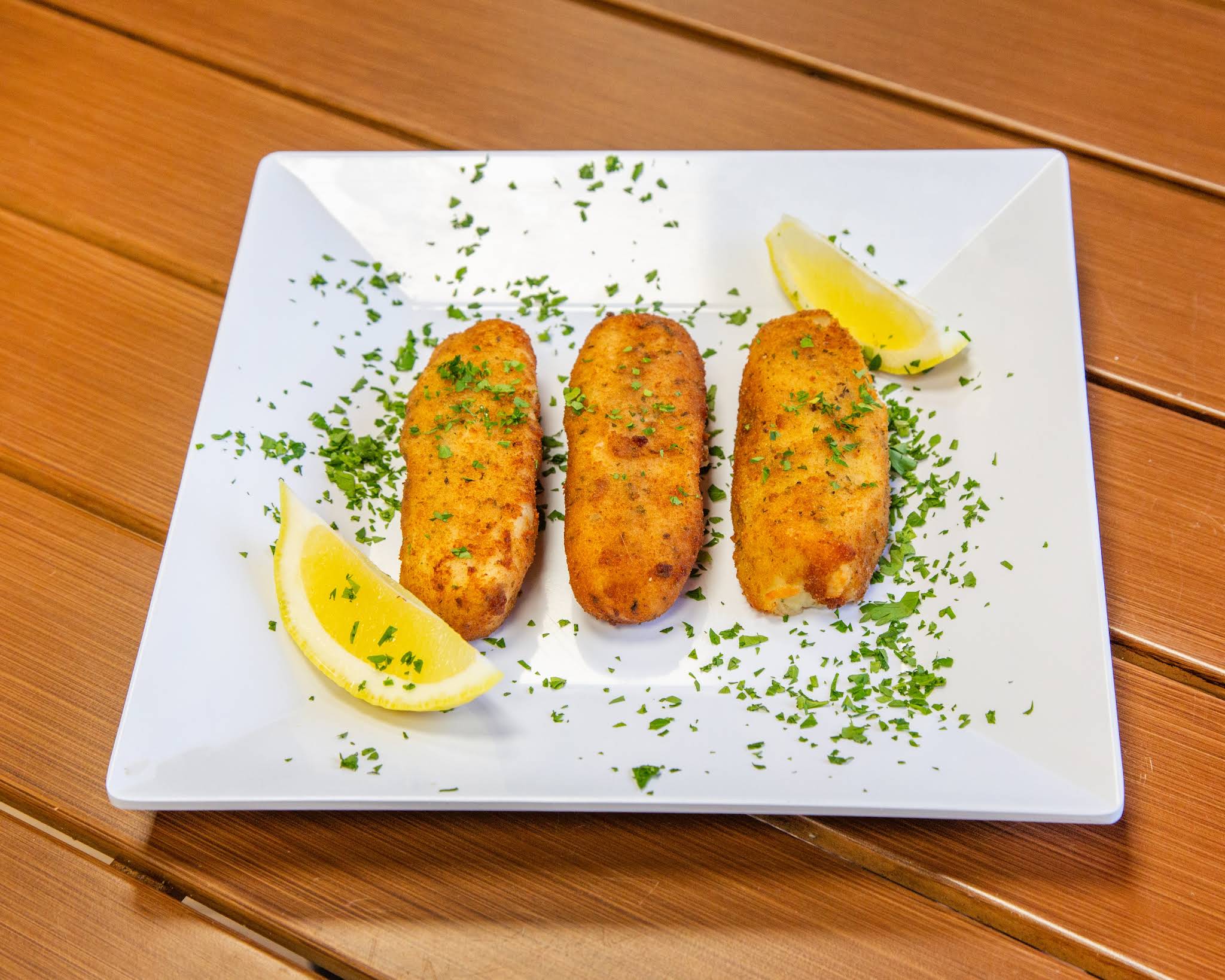 Fresh golden breaded cutlets with lemon, photographed by Terrible Eddie’s